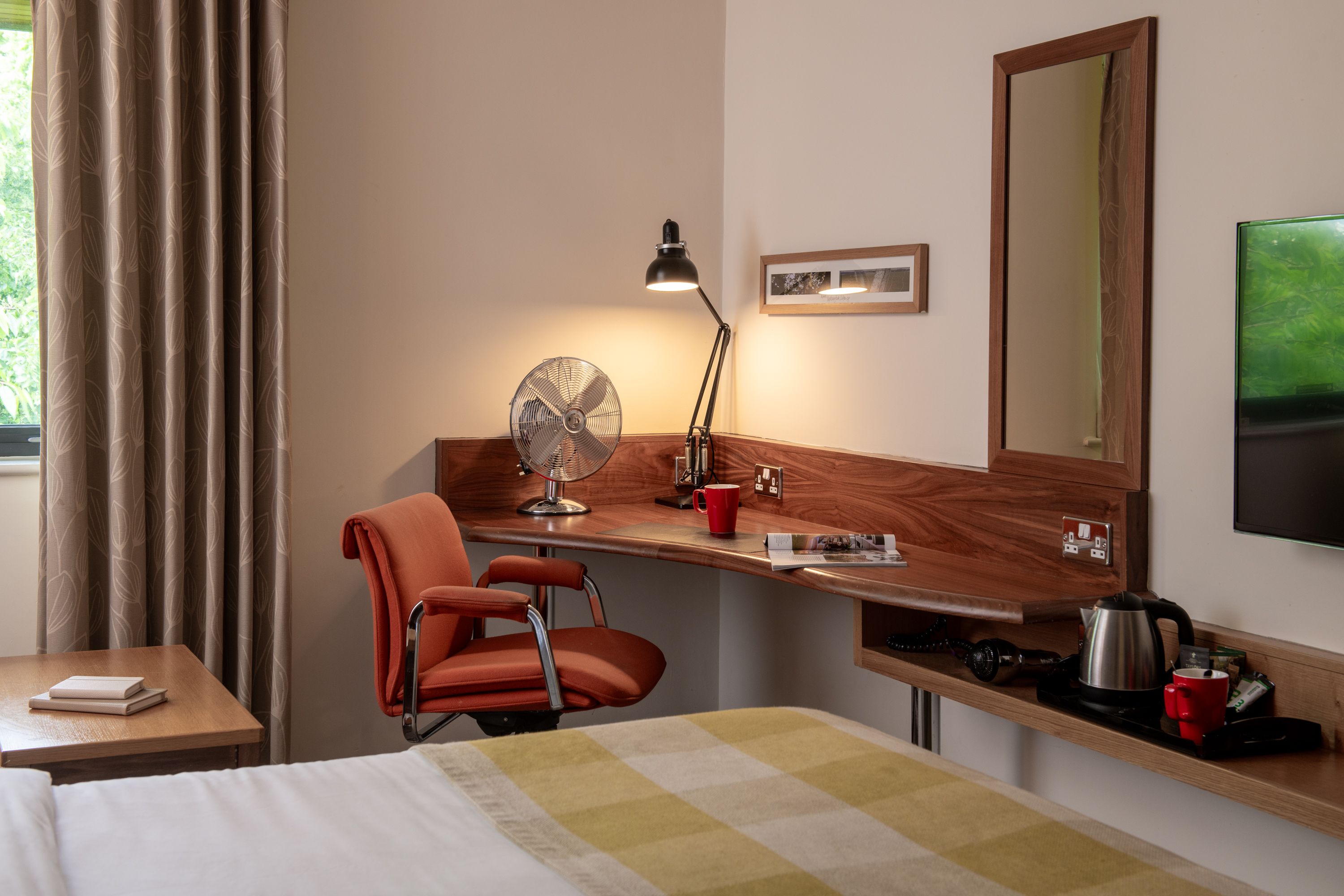 Close up of desk in lodge bedroom with task lamp turned on