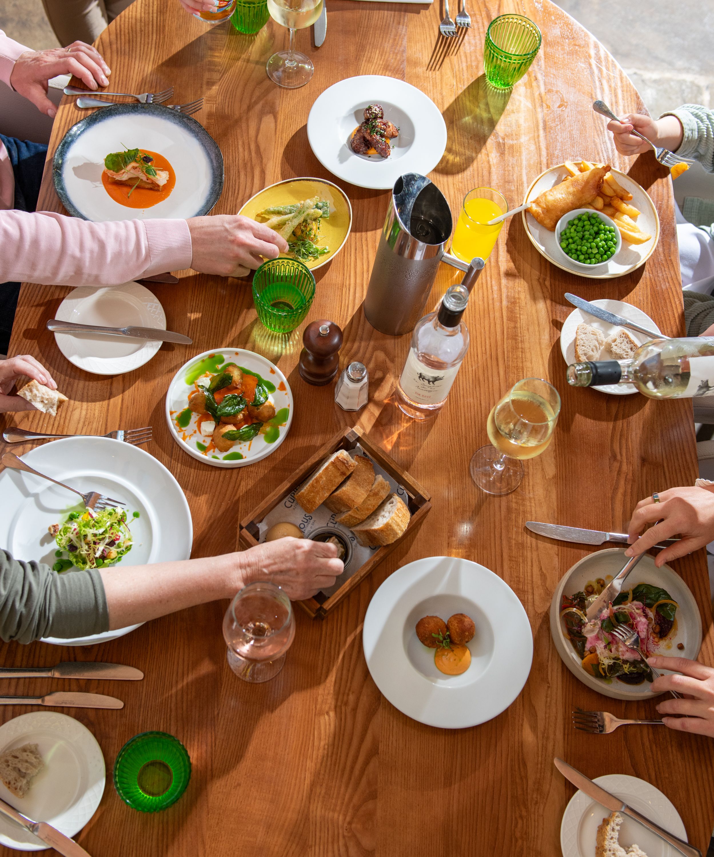 Birds eye view of people dining with an array of food on the table