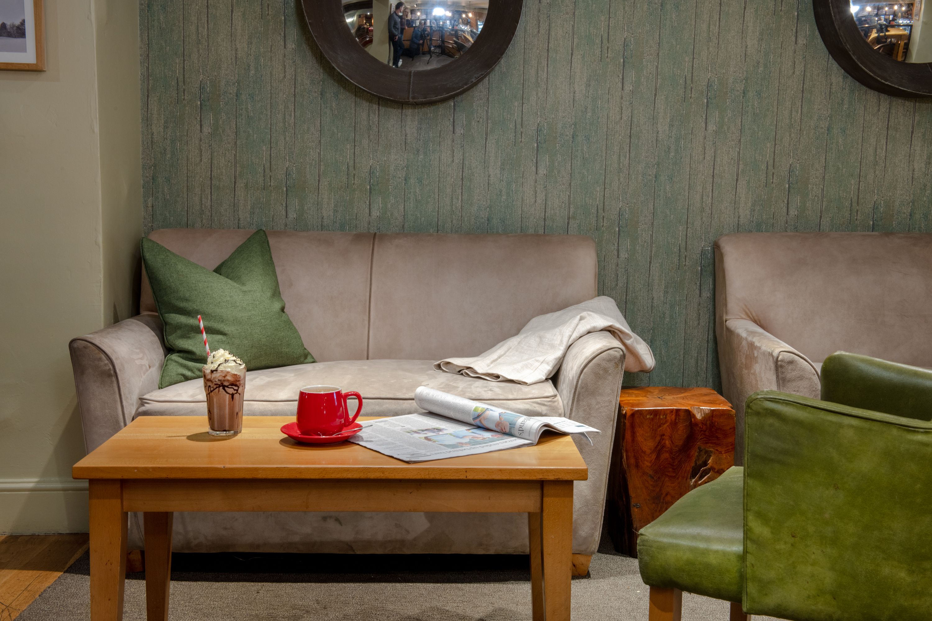 Sofa seat, with a frappe and magazine on coffee table