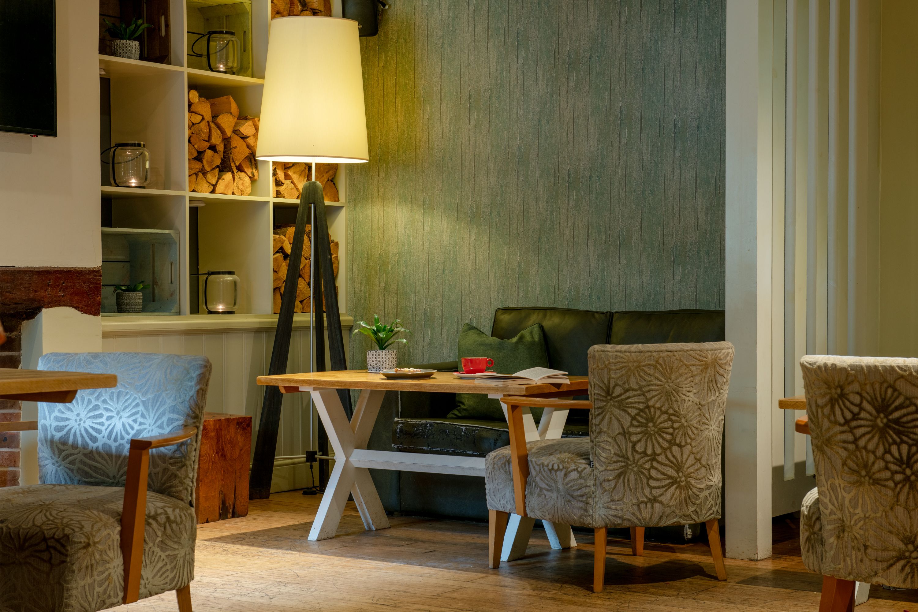 Cosy corner of The Black Sheep with a book and refreshments