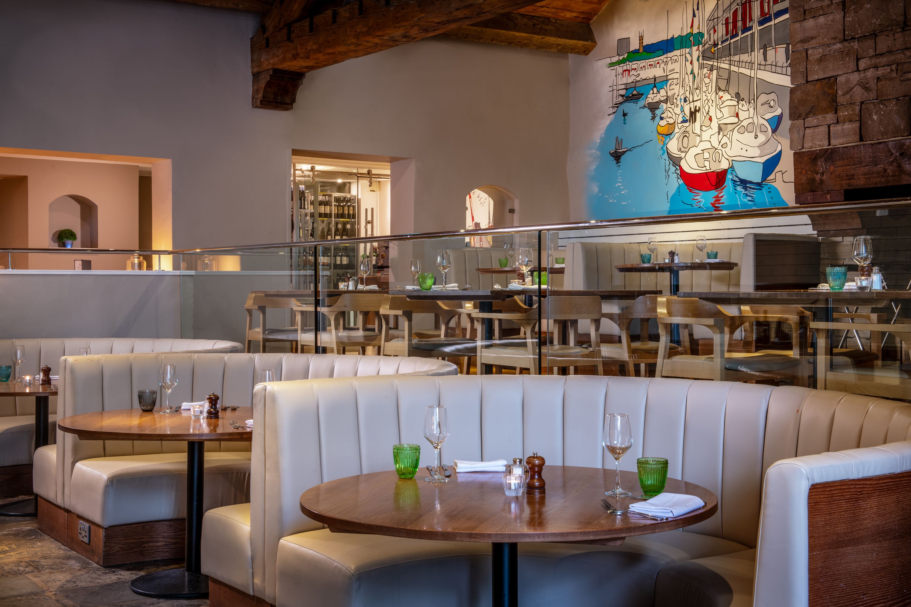 The Curious Kitchen dining area, with Bristol Harbour mural