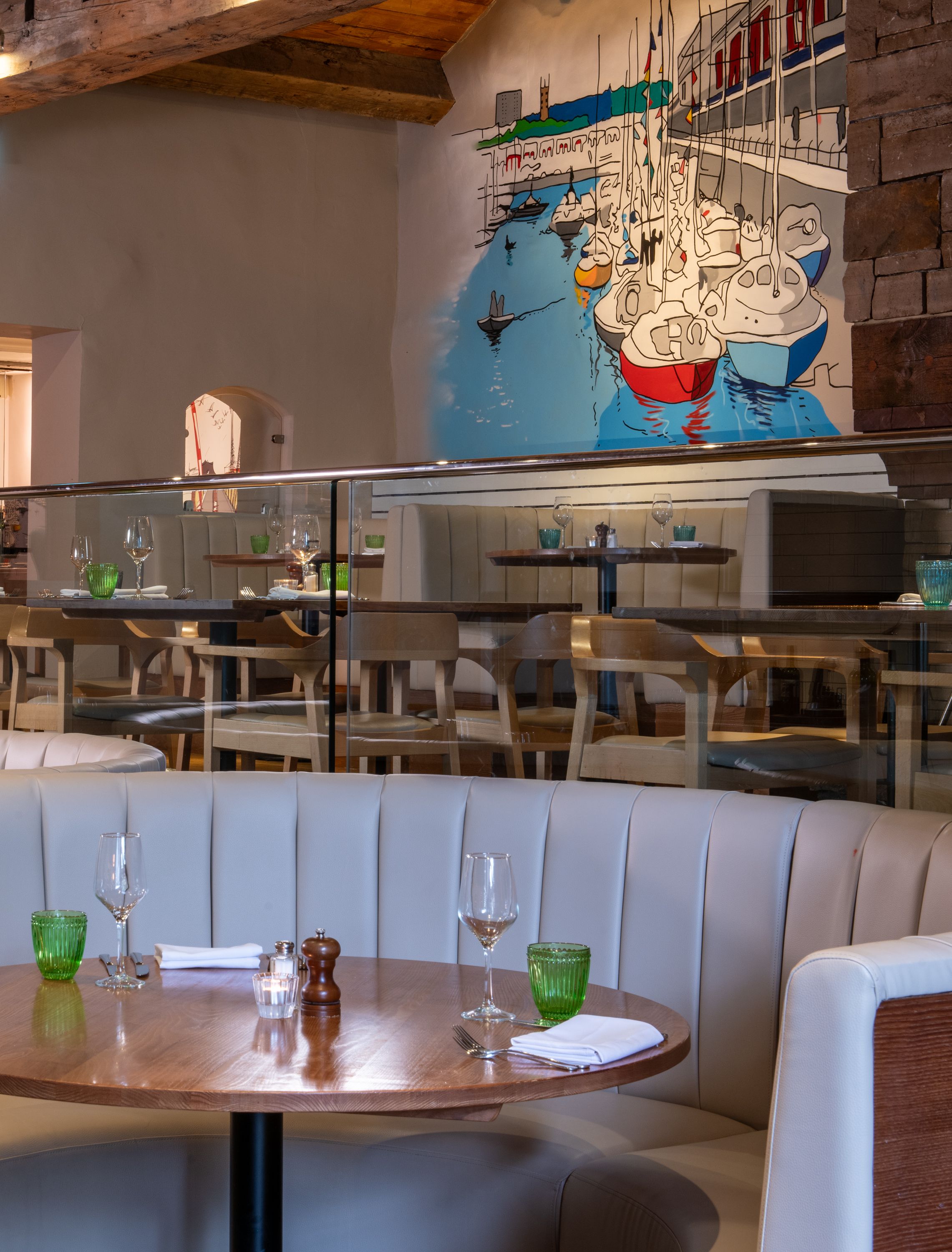 The Curious Kitchen dining area, with Bristol Harbour mural